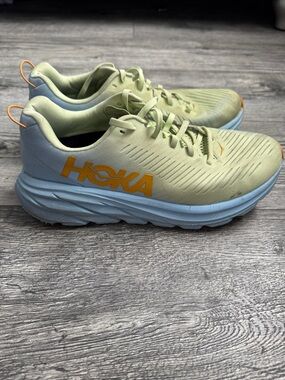Hoka Pale Green and Light Blue Running Shoes with Orange Logo